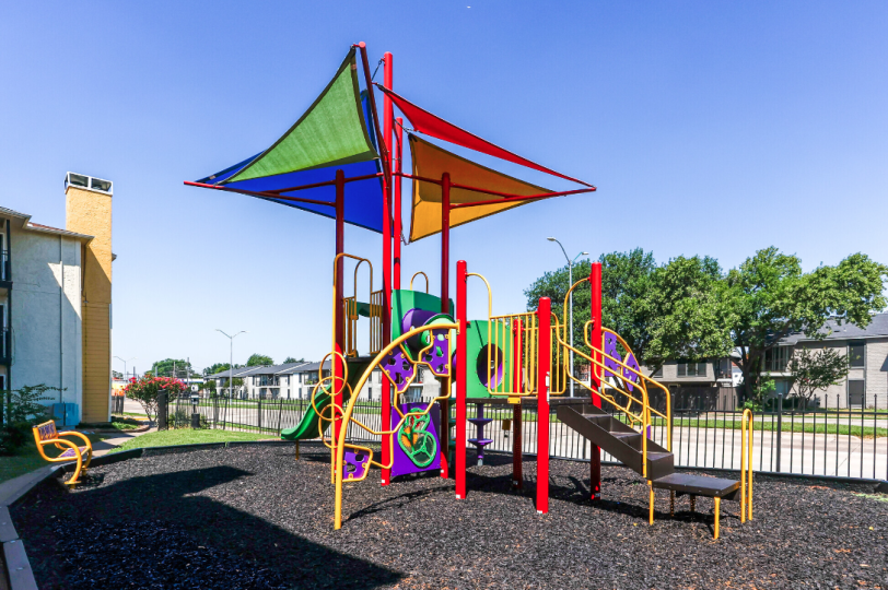 a green and yellow tent sitting under a fence